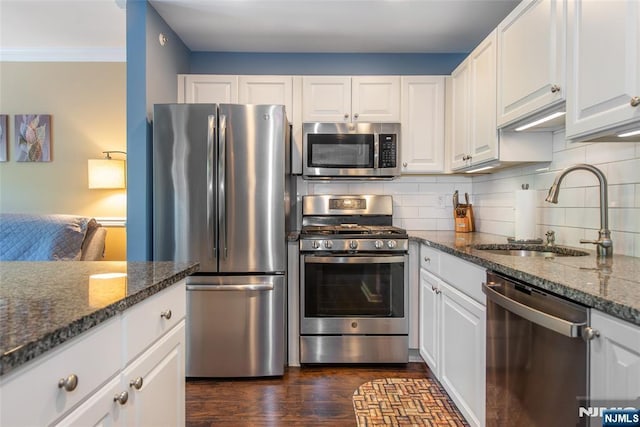 434 Cambridge Dr, Butler Borough, NJ 07405 - kitchen featuring appliances with stainless steel finishes, white cabinets, dark stone countertops, and crown molding
