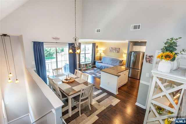 434 Cambridge Dr, Butler Borough, NJ 07405 - dining room with high vaulted ceiling, dark wood-type flooring, and a chandelier