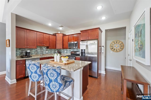 6 Elston Ct, Wanaque, NJ 07420 - kitchen with stainless steel appliances, dark wood-style flooring, light stone countertops, backsplash, and recessed lighting