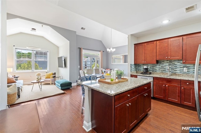 6 Elston Ct, Wanaque, NJ 07420 - kitchen featuring dishwasher, lofted ceiling, wood finished floors, a chandelier, and backsplash