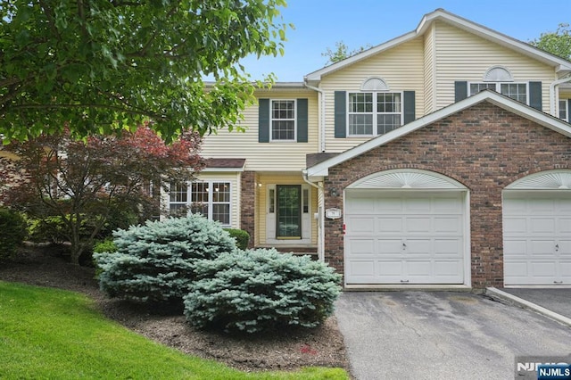 71 Butternut Dr Unit 71, Wayne, NJ 07470 - view of front of home featuring brick siding, an attached garage, and driveway