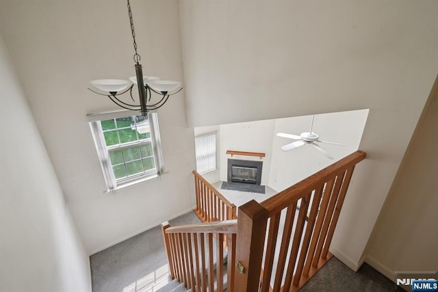 71 Butternut Dr Unit 71, Wayne, NJ 07470 - staircase with a high ceiling, carpet, a chandelier, a fireplace with flush hearth, and ceiling fan