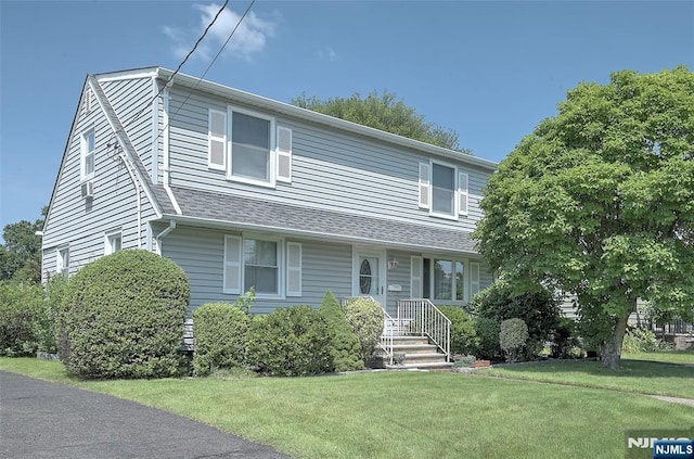 23 Bromley Pl, Bloomfield, NJ 07003 - view of front of home with a front lawn and a shingled roof