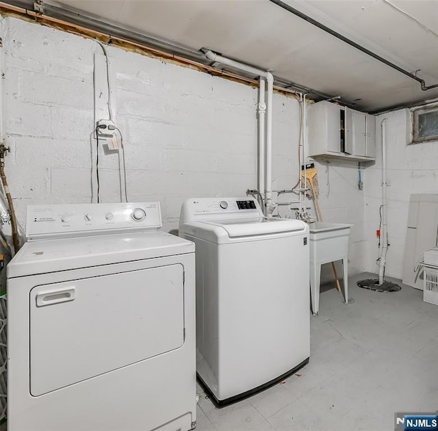 23 Bromley Pl, Bloomfield, NJ 07003 - laundry area with washing machine and clothes dryer and concrete block wall