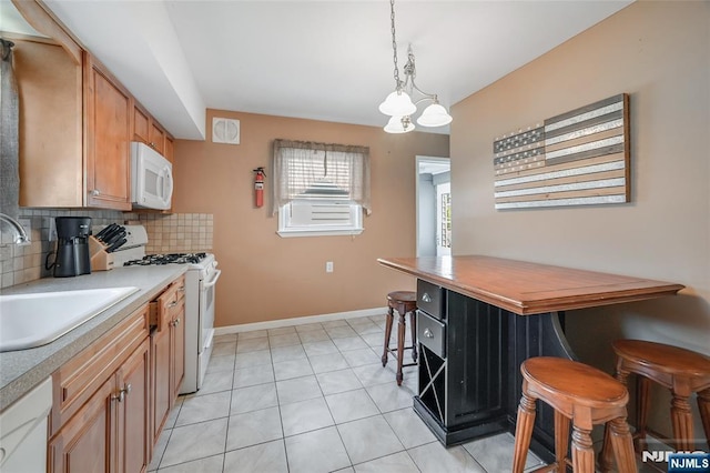 23 Bromley Pl, Bloomfield, NJ 07003 - kitchen with white appliances, light countertops, backsplash, decorative light fixtures, and light tile patterned floors