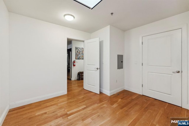 5711 Jefferson St Unit 405, West New York, NJ 07093 - unfurnished bedroom featuring electric panel, light wood-style floors, and a skylight