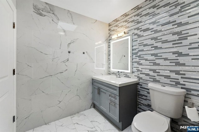 5711 Jefferson St Unit 405, West New York, NJ 07093 - bathroom featuring marble look tile flooring, vanity, and tile walls