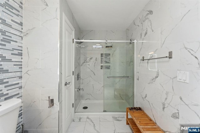5711 Jefferson St Unit 405, West New York, NJ 07093 - full bathroom featuring marble finish flooring, a marble finish shower, and tile walls