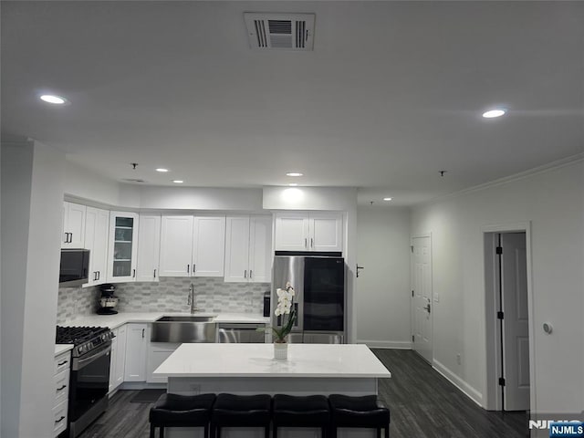500 Anderson Unit 104, Cliffside Park, NJ 07010 - kitchen with appliances with stainless steel finishes, recessed lighting, decorative backsplash, dark wood-style floors, and light countertops