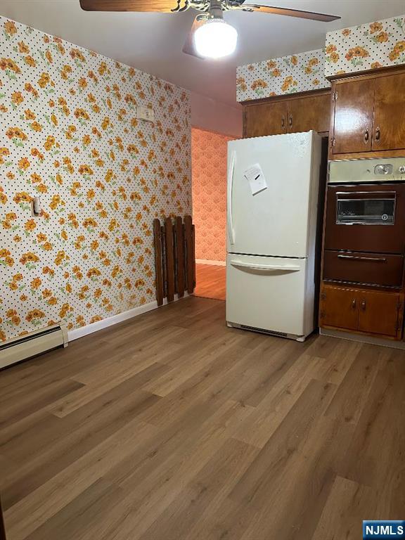 28 Stylon Rd, Wayne, NJ 07470 - kitchen featuring freestanding refrigerator, wallpapered walls, wall oven, light wood-type flooring, and ceiling fan