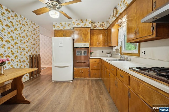 28 Stylon Rd, Wayne, NJ 07470 - kitchen featuring stainless steel oven, under cabinet range hood, freestanding refrigerator, wallpapered walls, and a warming drawer