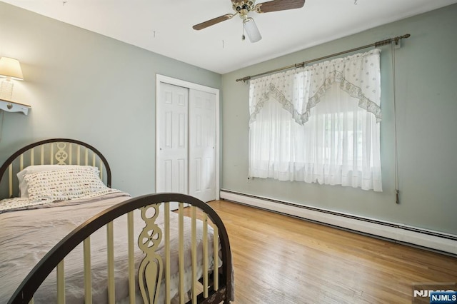 28 Stylon Rd, Wayne, NJ 07470 - bedroom with a baseboard heating unit, a closet, wood finished floors, and a ceiling fan