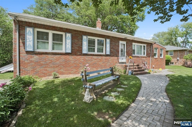 28 Stylon Rd, Wayne, NJ 07470 - view of front of property featuring brick siding, a front yard, and a chimney