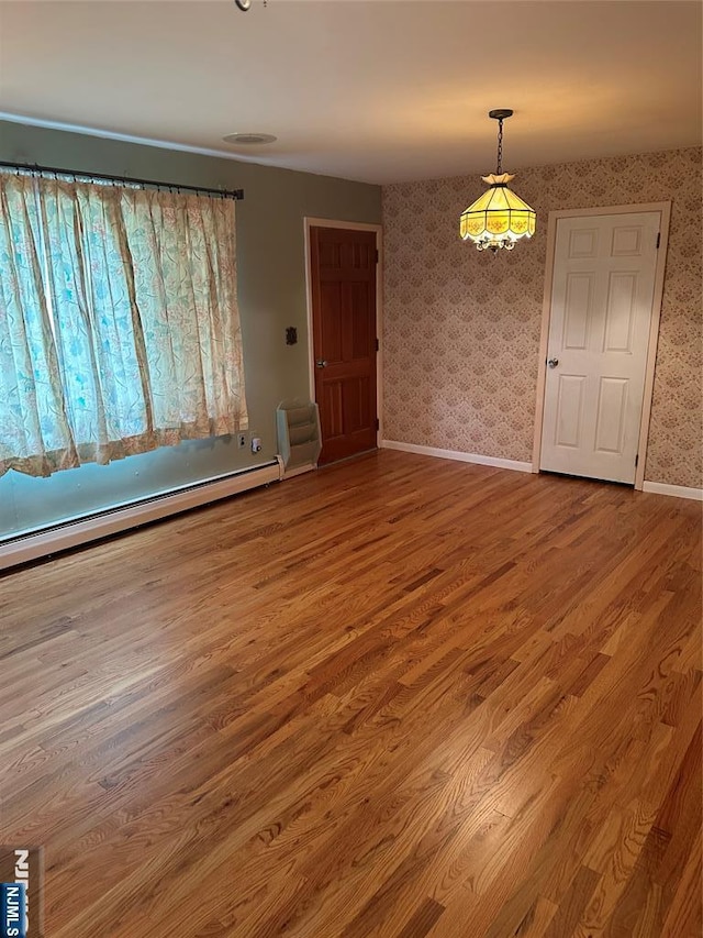 28 Stylon Rd, Wayne, NJ 07470 - unfurnished room featuring wallpapered walls, wood finished floors, and a baseboard radiator