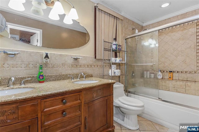 320 Clifton Ave, Newark, NJ 07104 - full bath featuring tile walls, tile patterned floors, double vanity, combined bath / shower with glass door, and crown molding