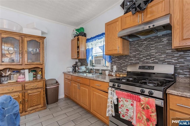 320 Clifton Ave, Newark, NJ 07104 - kitchen with stainless steel range with gas stovetop, under cabinet range hood, tasteful backsplash, light wood-type flooring, and ornamental molding