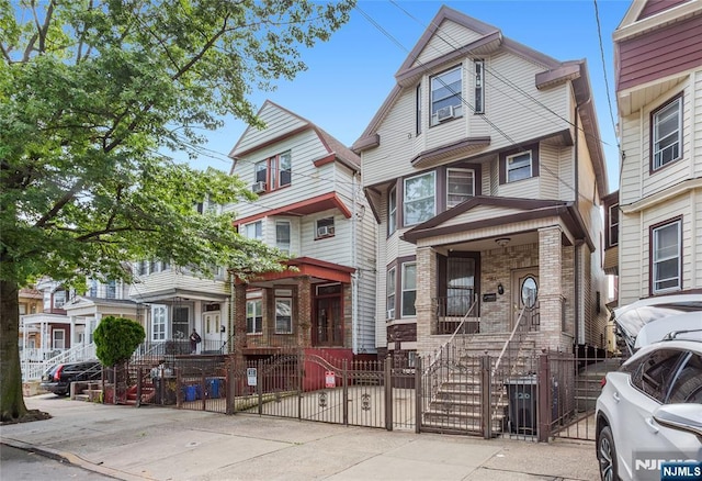 320 Clifton Ave, Newark, NJ 07104 - townhome / multi-family property featuring a fenced front yard, a gate, and brick siding