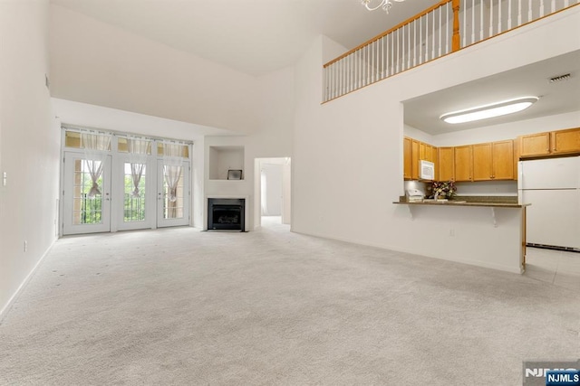 7303 Ravenscroft Rd Unit 570, Clifton, NJ 07013 - unfurnished living room with a high ceiling, light carpet, and a fireplace