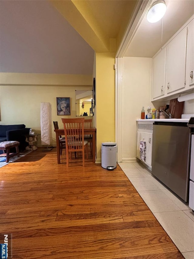 3081 Edwin Unit 2E, Fort Lee, NJ 07024 - kitchen with white cabinetry, light wood-style floors, open floor plan, and washer / dryer
