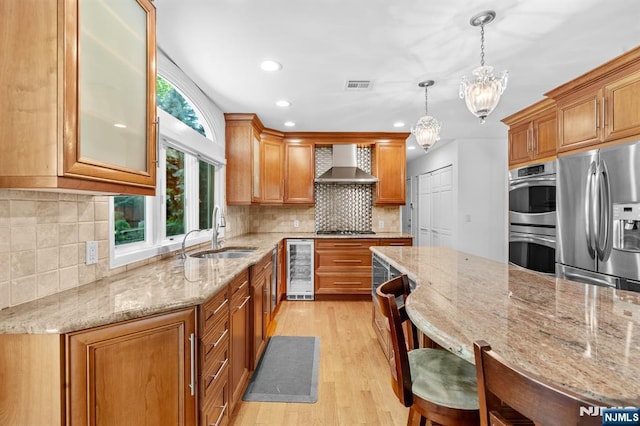 506 Salem St, Paramus, NJ 07652 - kitchen featuring appliances with stainless steel finishes, wall chimney range hood, beverage cooler, light wood-style flooring, and backsplash