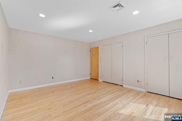 506 Salem St, Paramus, NJ 07652 - unfurnished bedroom featuring multiple closets, wood finished floors, and recessed lighting