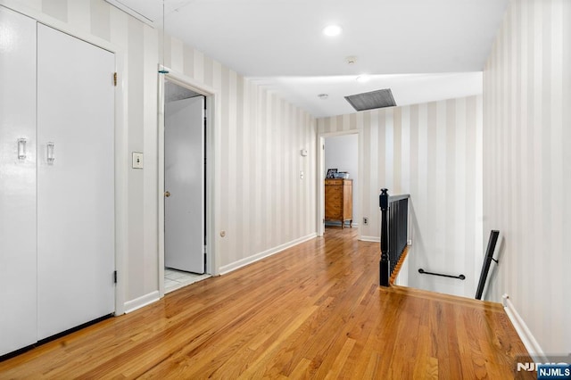 506 Salem St, Paramus, NJ 07652 - corridor with an upstairs landing, wood finished floors, wallpapered walls, and attic access