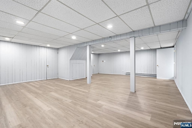 506 Salem St, Paramus, NJ 07652 - finished below grade area with wood finished floors, a drop ceiling, recessed lighting, and a baseboard heating unit