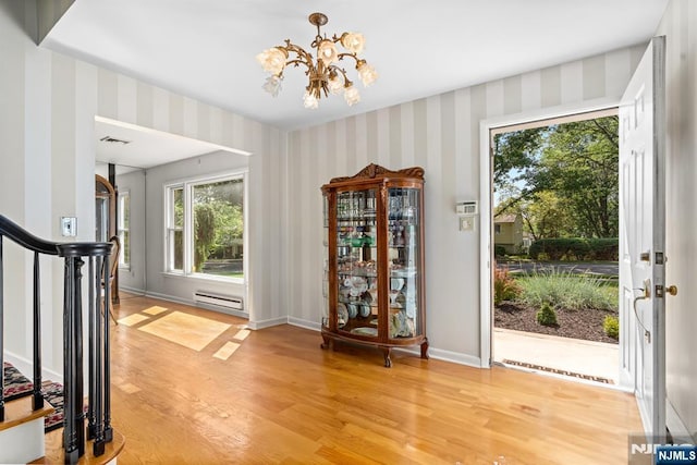 506 Salem St, Paramus, NJ 07652 - entryway with baseboard heating, light wood-style floors, a chandelier, wallpapered walls, and stairway