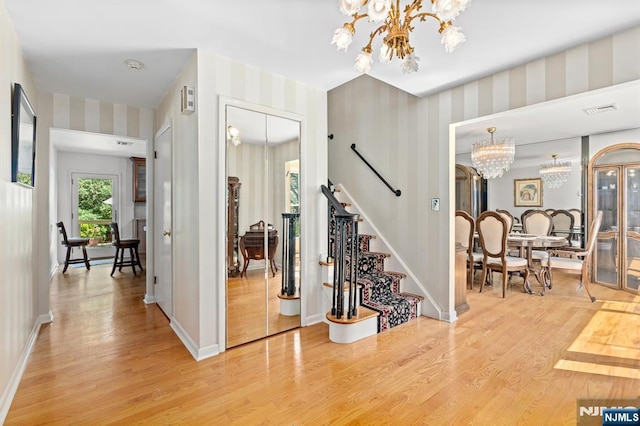 506 Salem St, Paramus, NJ 07652 - entryway with a chandelier, wallpapered walls, light wood finished floors, and stairway