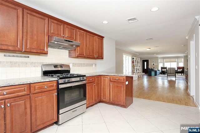 400 Lawton Ave Unit C0400, Cliffside Park, NJ 07010 - kitchen featuring stainless steel gas stove, under cabinet range hood, a peninsula, brown cabinets, and recessed lighting