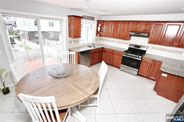 400 Lawton Ave Unit C0400, Cliffside Park, NJ 07010 - kitchen with appliances with stainless steel finishes, under cabinet range hood, decorative backsplash, light tile patterned flooring, and recessed lighting