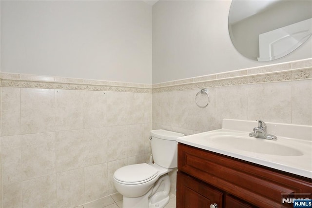 400 Lawton Ave Unit C0400, Cliffside Park, NJ 07010 - half bath featuring tile walls, vanity, a wainscoted wall, and tile patterned flooring