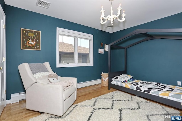 400 Lawton Ave Unit C0400, Cliffside Park, NJ 07010 - bedroom featuring a baseboard heating unit, wood finished floors, and a chandelier