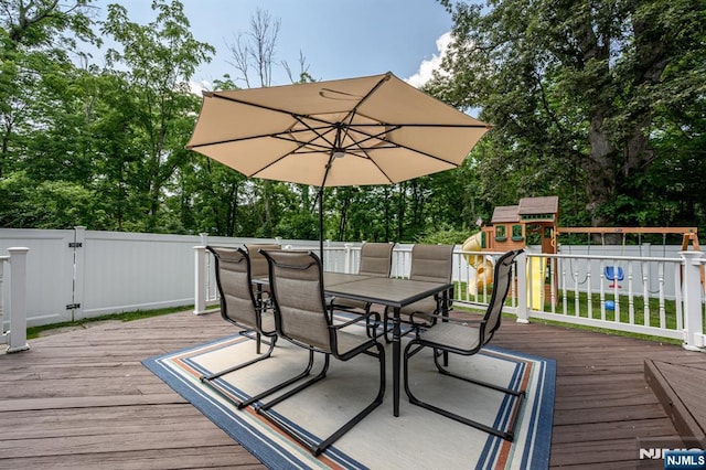 20 Card St, Hamburg, NJ 07419 - deck featuring a playground, outdoor dining space, a fenced backyard, and view of scattered trees