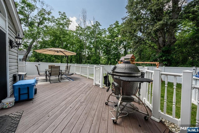 20 Card St, Hamburg, NJ 07419 - wooden deck with outdoor dining area, grilling area, a fenced backyard, and view of scattered trees