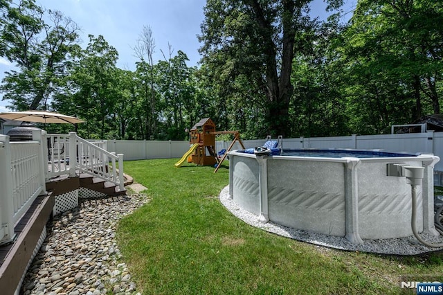 20 Card St, Hamburg, NJ 07419 - fenced backyard with a wooden deck, a playground, and view of wooded area