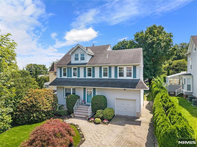 147 Grant Ave, Nutley, NJ 07110 - view of front of house with a garage, decorative driveway, and a shingled roof
