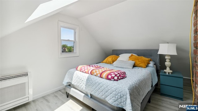 80 Union Ave, Little Ferry, NJ 07643 - bedroom with wood finished floors, a skylight, vaulted ceiling, and heating unit