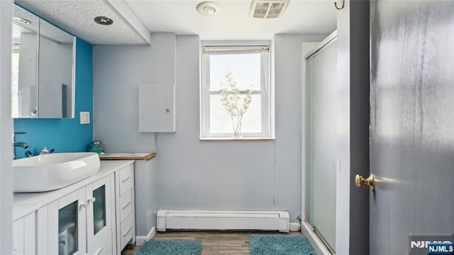 80 Union Ave, Little Ferry, NJ 07643 - full bathroom featuring a baseboard radiator, vanity, wood finished floors, and a stall shower