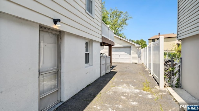 80 Union Ave, Little Ferry, NJ 07643 - view of patio featuring an outdoor structure, driveway, and a garage