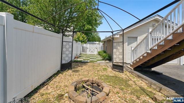 80 Union Ave, Little Ferry, NJ 07643 - fenced yard with an outdoor fire pit, stairs, a gate, and a wooden deck