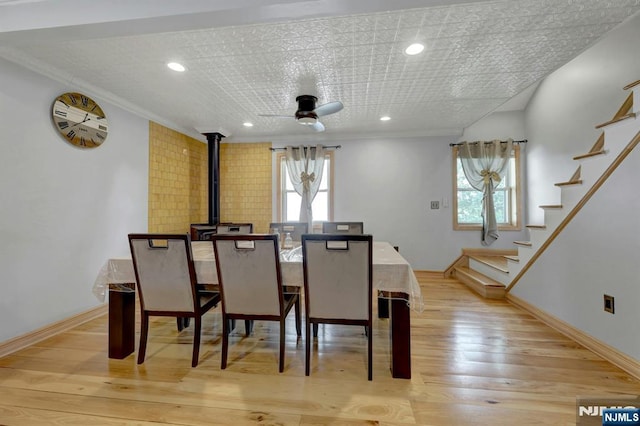 14 N Railroad Ave, Mahwah, NJ 07430 - dining room with healthy amount of natural light, a ceiling fan, a wood stove, stairs, and ornamental molding