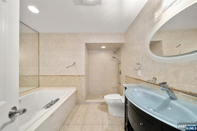 300 Gorge Rd Unit 1, Cliffside Park, NJ 07010 - bathroom with tile walls, a bath, a tile shower, vanity, and tile patterned flooring