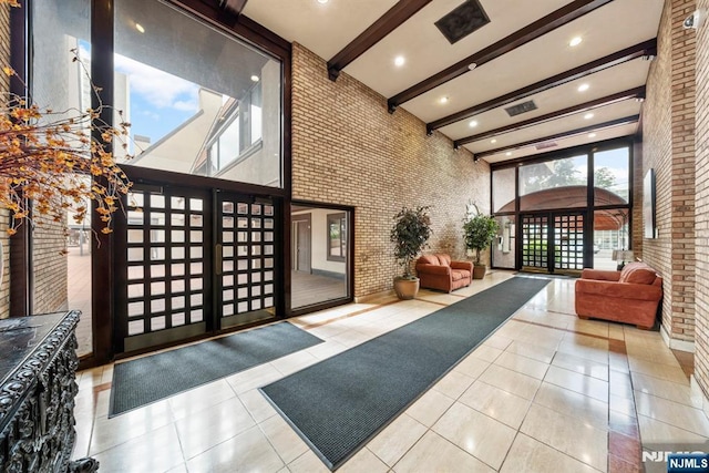 300 Gorge Rd Unit 1, Cliffside Park, NJ 07010 - lobby with a towering ceiling, beam ceiling, brick wall, and recessed lighting