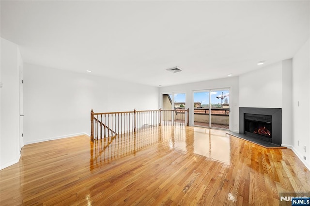 300 Gorge Rd Unit 1, Cliffside Park, NJ 07010 - unfurnished living room with wood finished floors, a warm lit fireplace, and recessed lighting