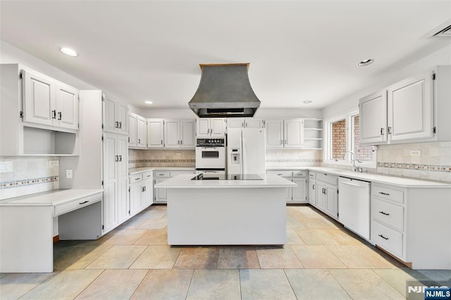 300 Gorge Rd Unit 1, Cliffside Park, NJ 07010 - kitchen featuring white appliances, open shelves, island exhaust hood, a kitchen island, and decorative backsplash