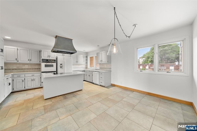 300 Gorge Rd Unit 1, Cliffside Park, NJ 07010 - kitchen with white appliances, island exhaust hood, decorative backsplash, light countertops, and recessed lighting