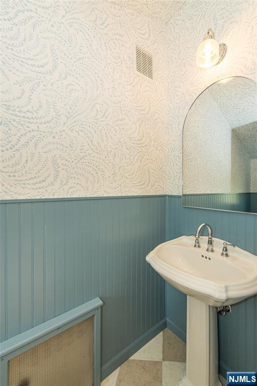 146 Raab Ave, Bloomfield, NJ 07003 - bathroom with wallpapered walls and a wainscoted wall