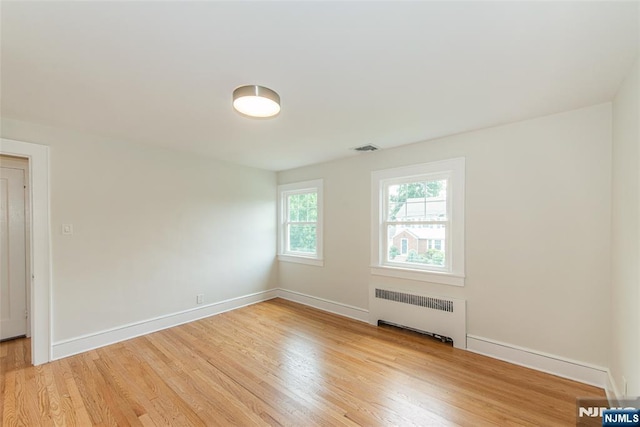 146 Raab Ave, Bloomfield, NJ 07003 - unfurnished room featuring radiator heating unit and light wood-type flooring