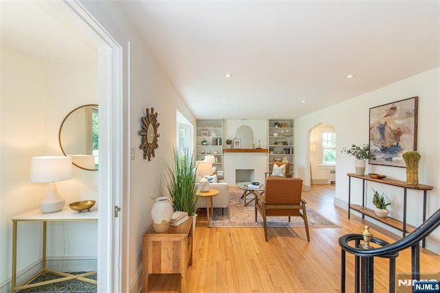146 Raab Ave, Bloomfield, NJ 07003 - living area with arched walkways, light wood-type flooring, built in features, and recessed lighting